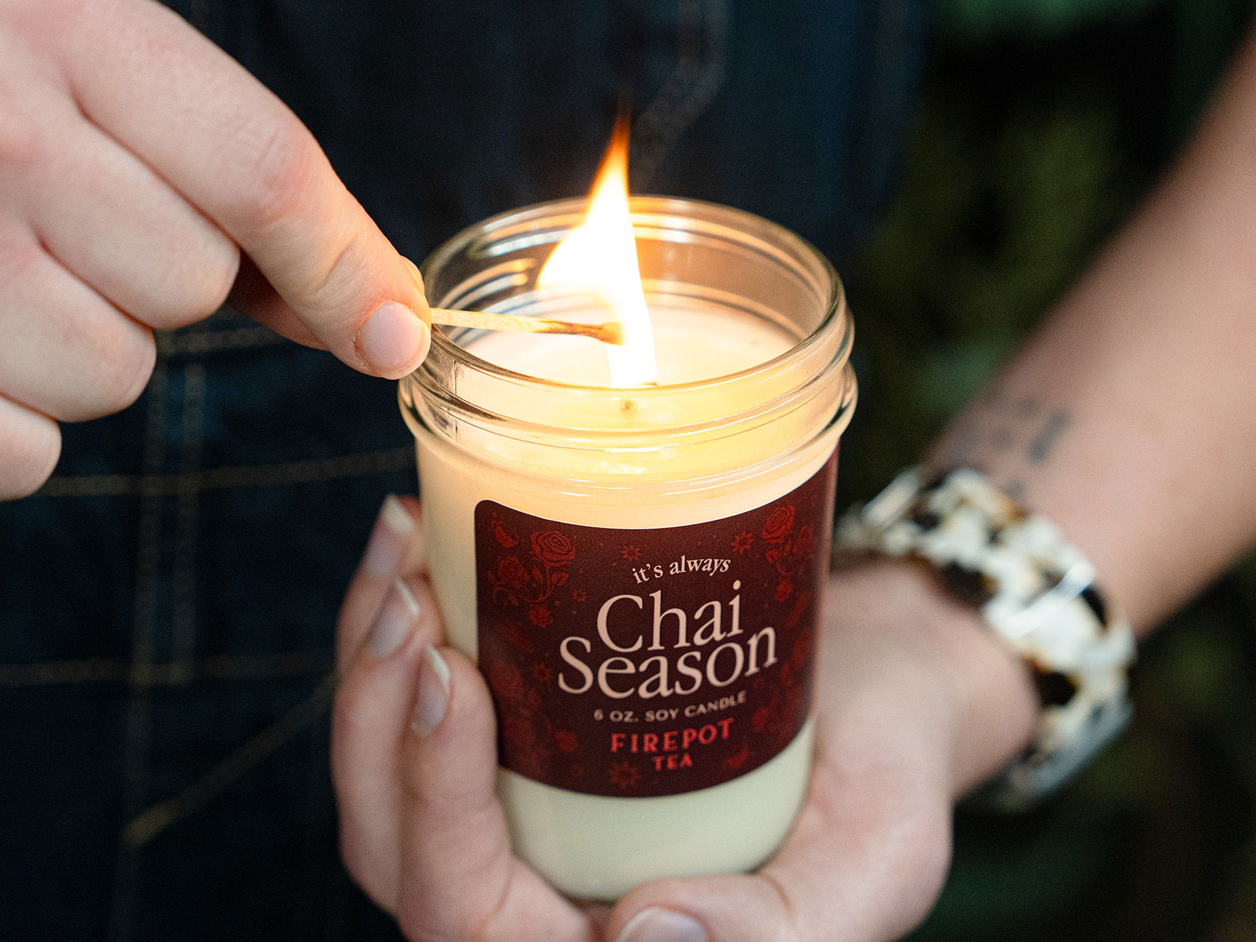 image of person lighting the chai season candle