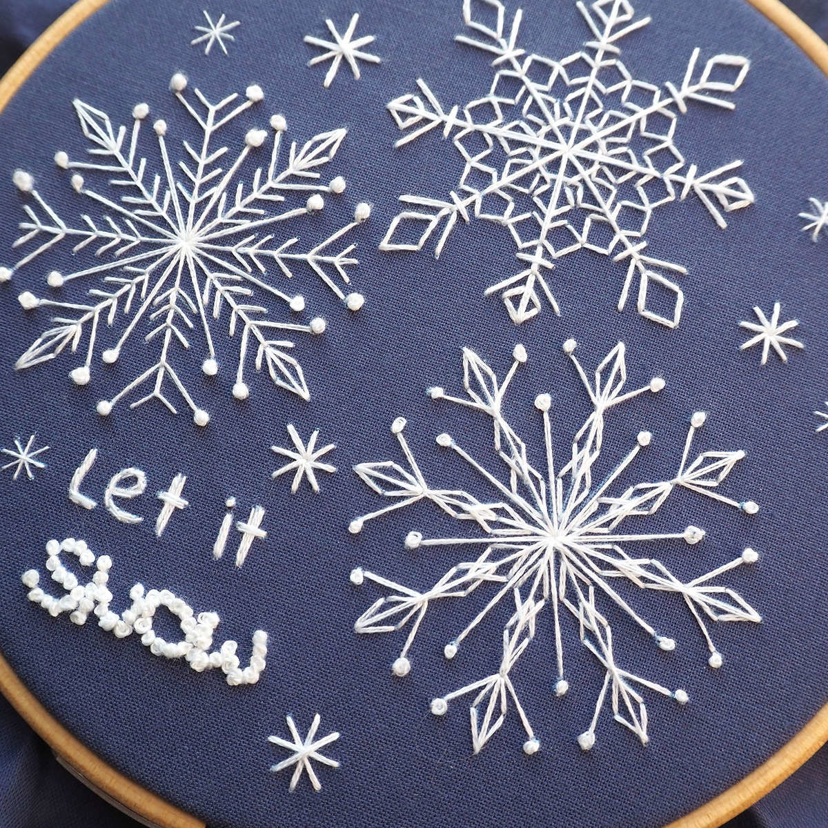 Embroidery snowflake pattern with different sized snowflakes