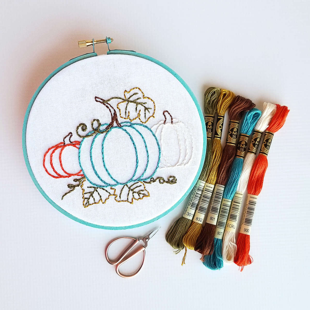 Pumpkin trio hand embroidery pattern stitched in orange, turquoise, and off white