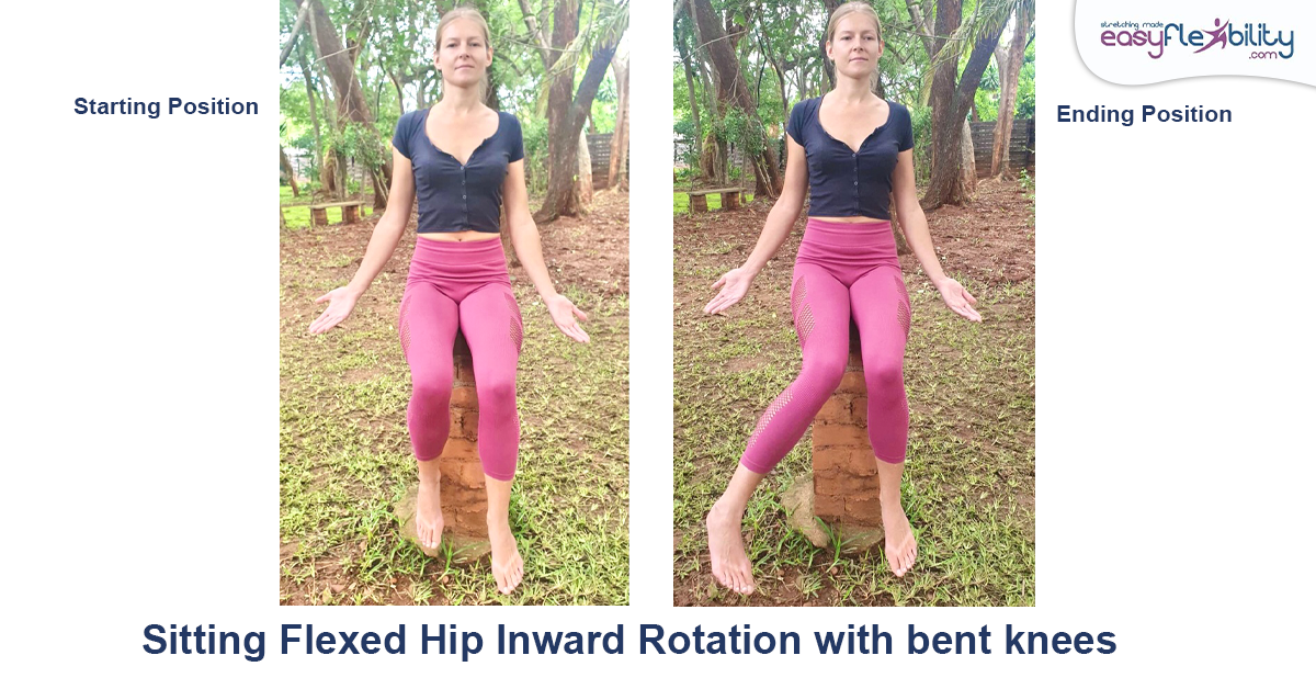 A woman sitting on a stack of bricks doing hip inward rotation with bent knees