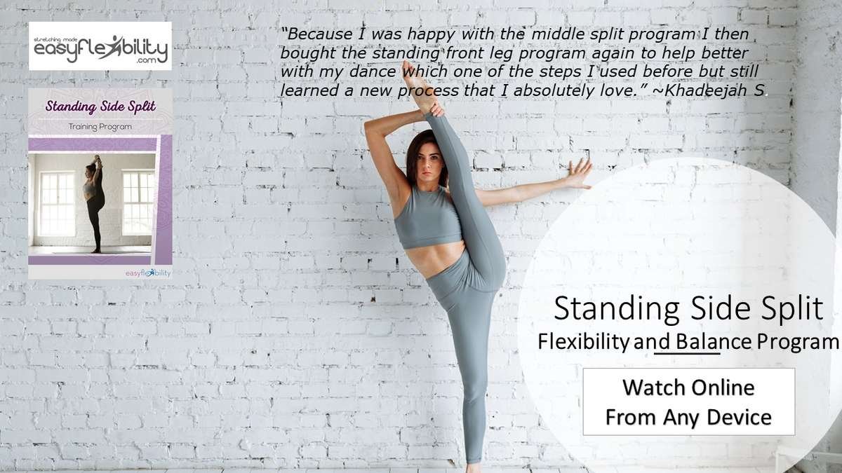 Woman practicing standing bow pose stock photo