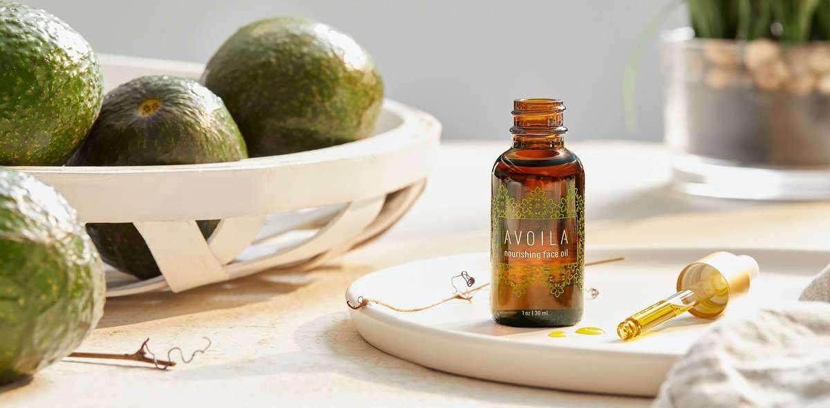 Avoila Nourishing Face Oil on counter with avocados