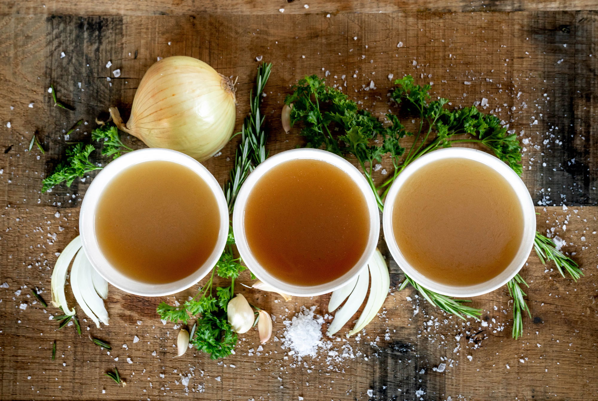 row of three cups of bone broth with organic ingredients row of three cups of bone broth with organic ingredients