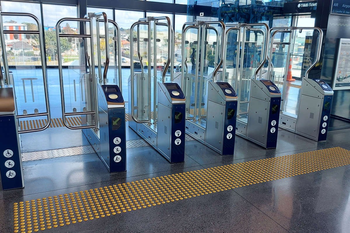 TacPro yellow polyurethane tactile indicators at both sides of ticket gate turnstiles