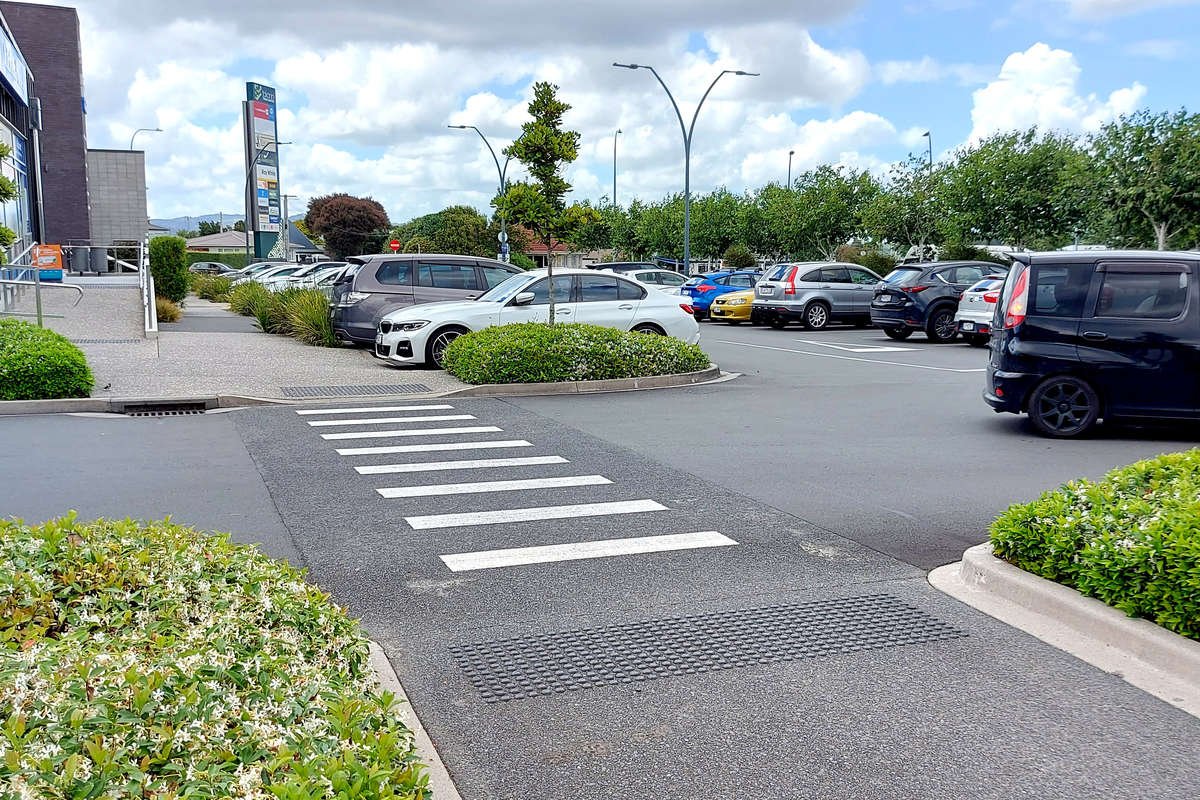 TacPro black polyurethane tactile indicators installed at either side of a carpark zebra crossing.