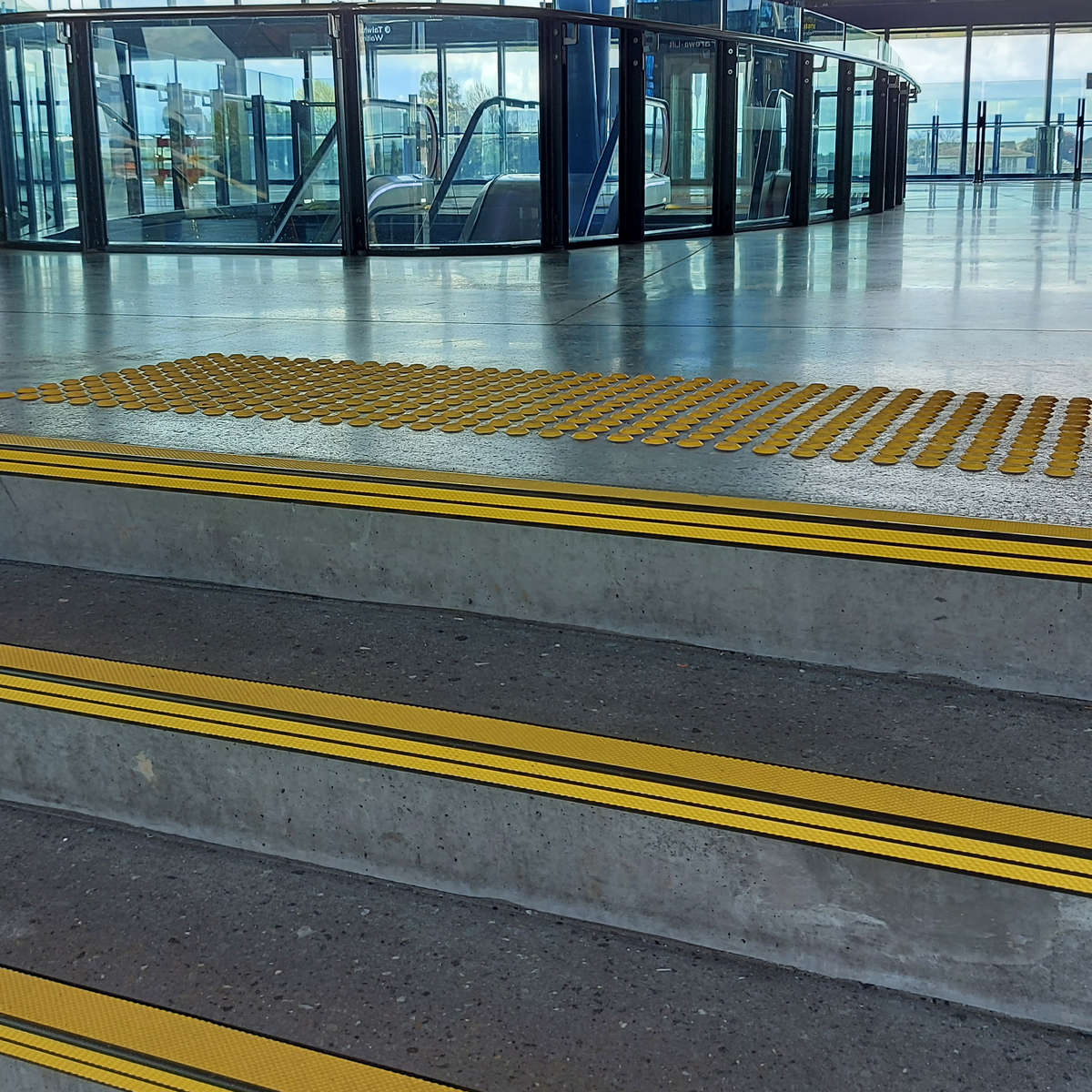 TacPro yellow polyurethane warning tactile indicators and stair nosing installed to precast concrete stairs