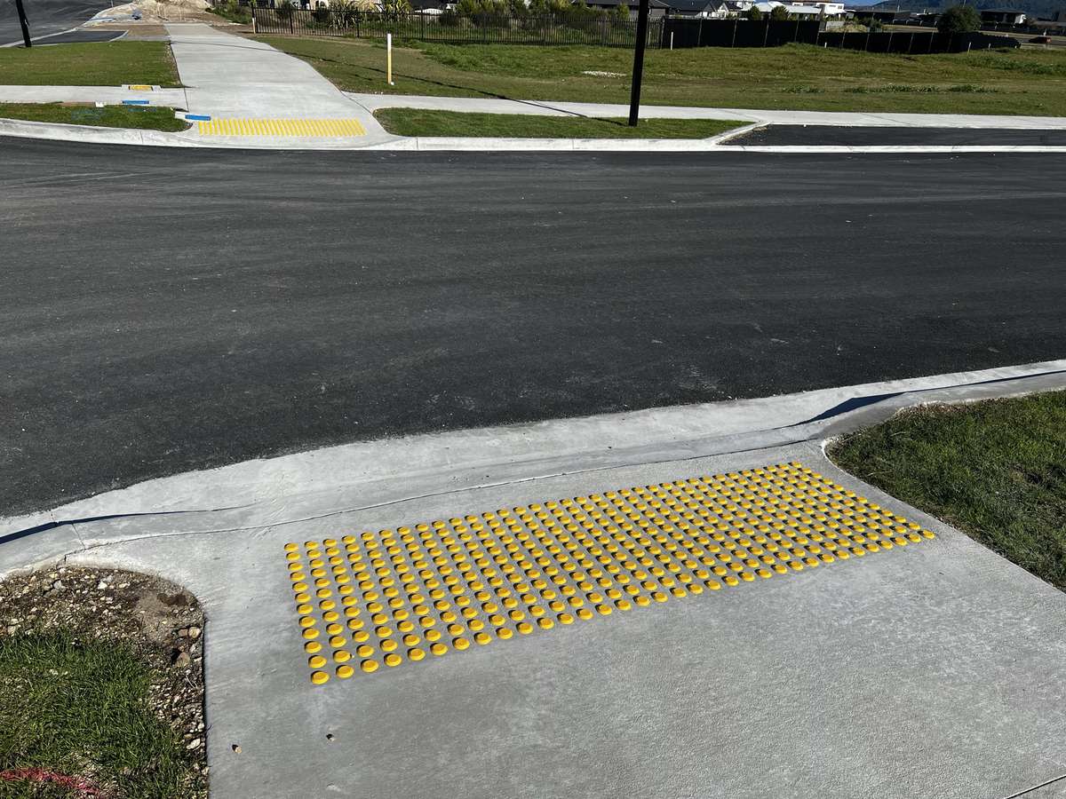 TacPro yellow polyurethane tactile indicators on concrete at a new subdivision pram crossing (3)