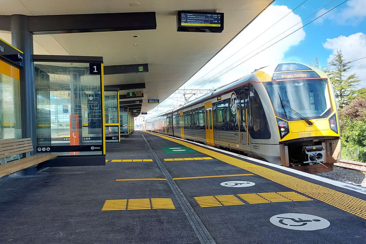 Train stopped on platform with TacPro yellow polyurethane tactile indicators installed to platform edge and miscellaneous