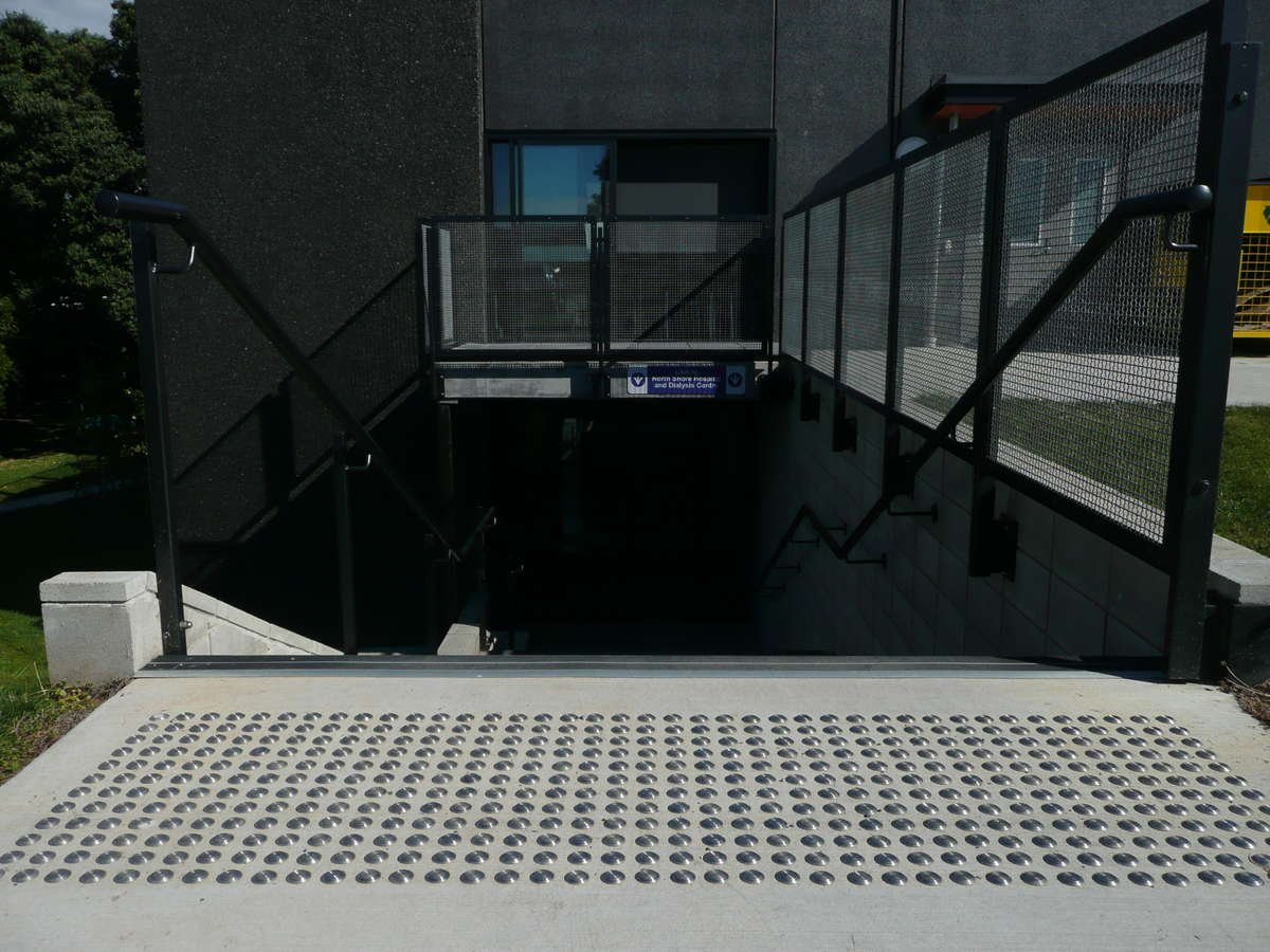 TacPro stainless steel tactile indicators installed on concrete at top of stairs