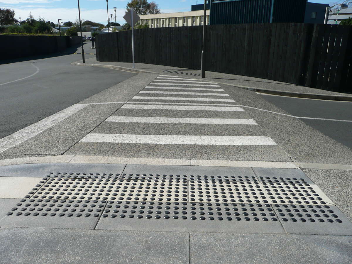 TacPro black polyurethane tactile indicators installed on bluestone tiles at zebra crossing outside retirement village (2)