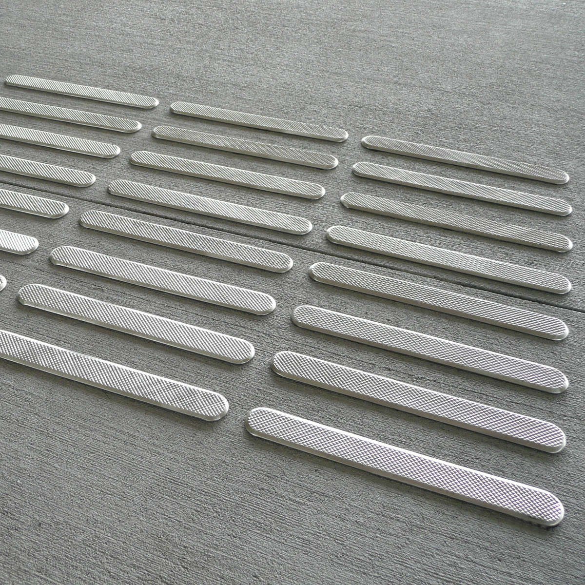 A close-up of TacPro stainless steel directional tactile indicator bars
