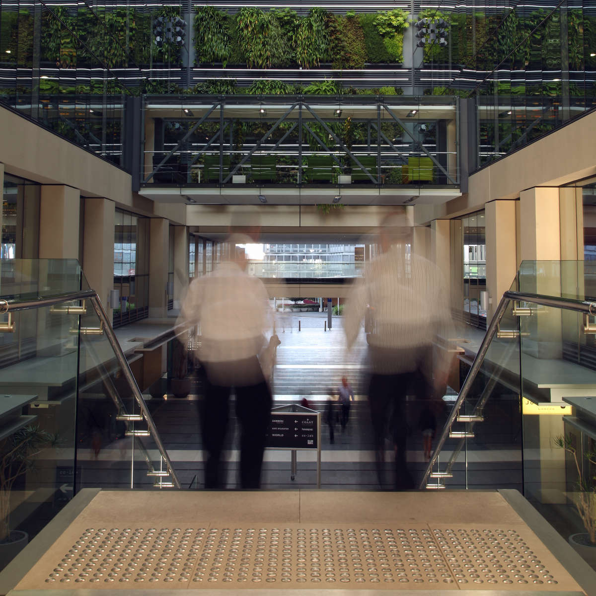 People using stairs with TacPro stainless steel tactile indicators installed at the top