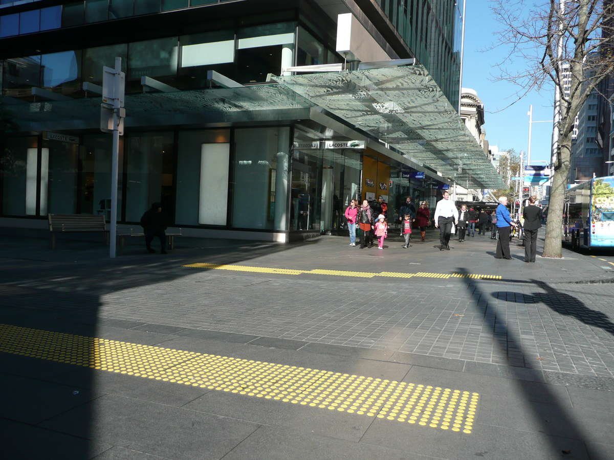 Yellow polyurethane tactile indicators at city pedestrian crossing