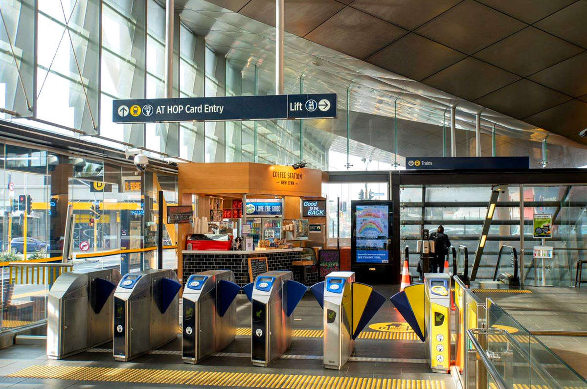 TacPro yellow polyurethane tactile indicators on either side of the train station ticket machine turnstiles