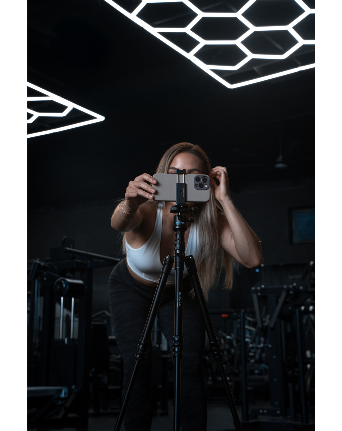 iphone attached to tripod at a gym