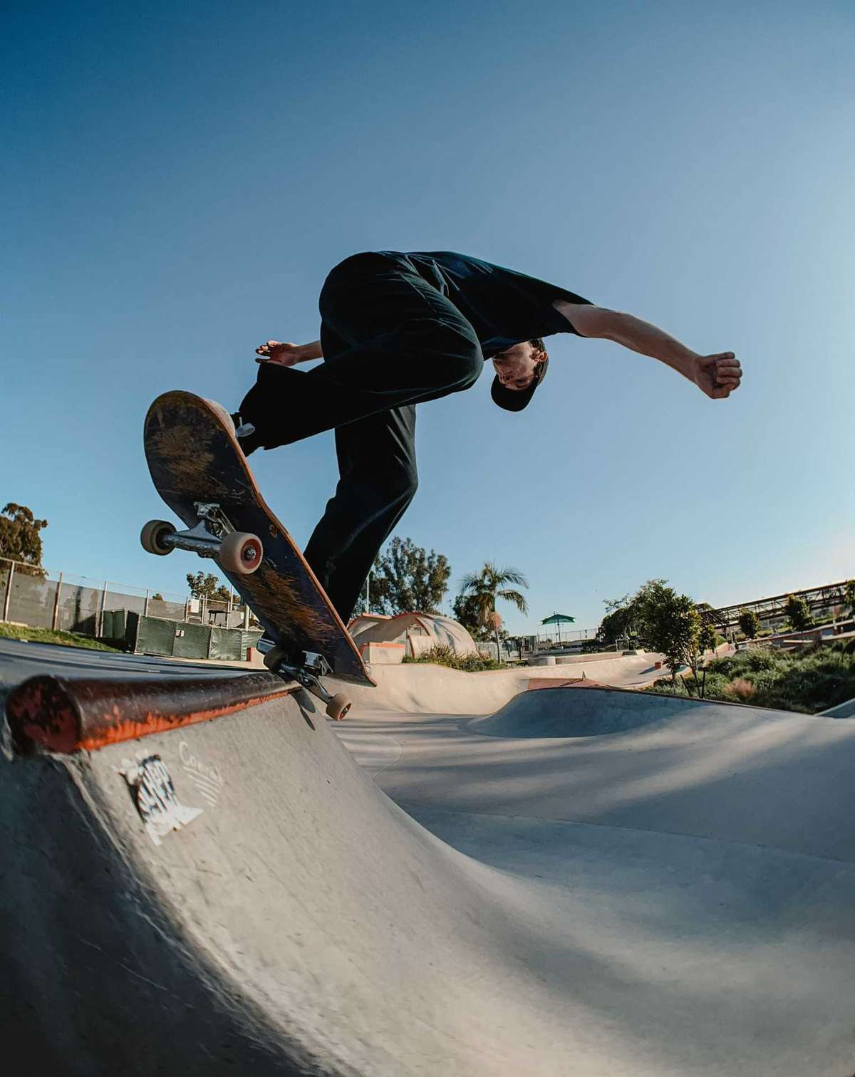 Fisheye shot on man on skateboard in a skatepark. 