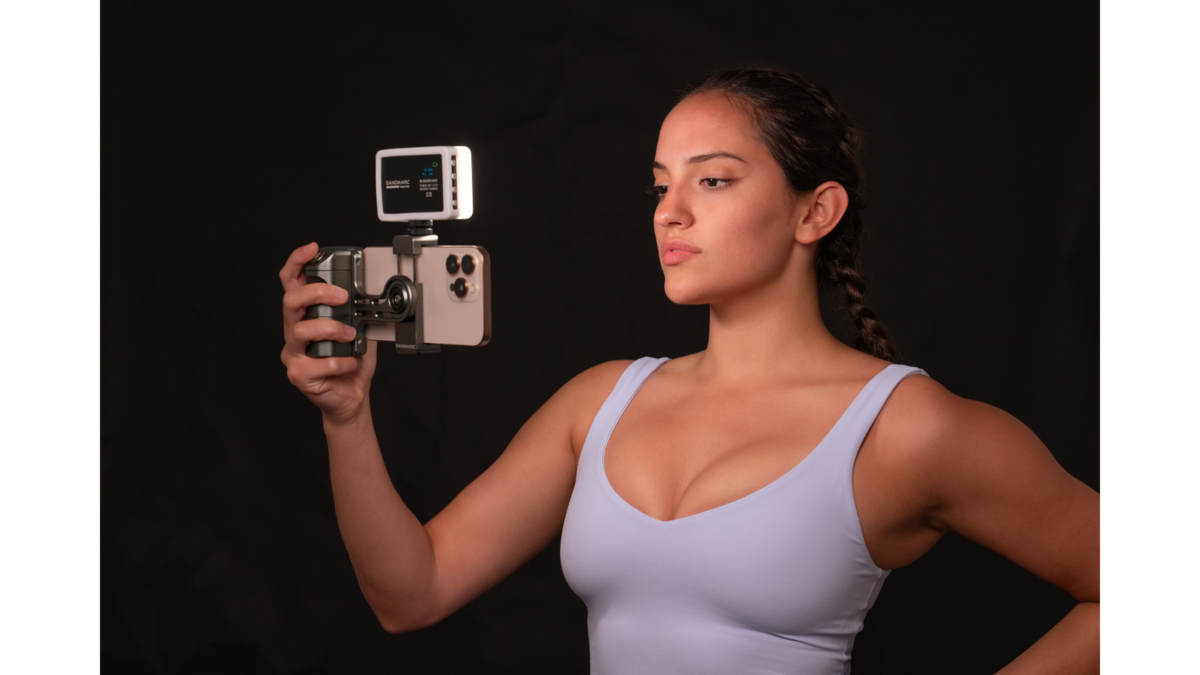 woman holding iphone stabilizer with an attached light for fitness content creation