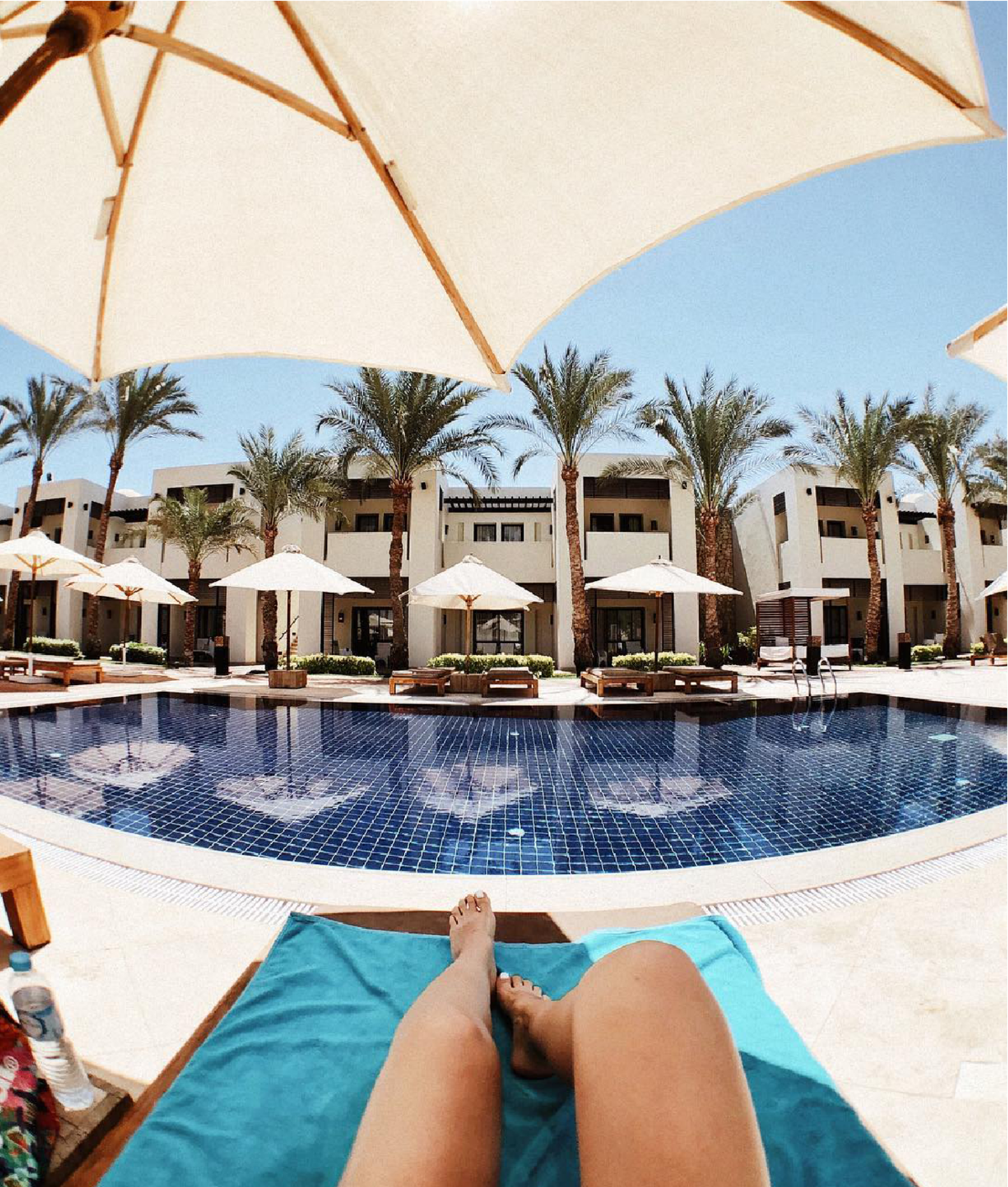 Captured on SANDMARC's Fisheye lens, a girl tanning at a resort
