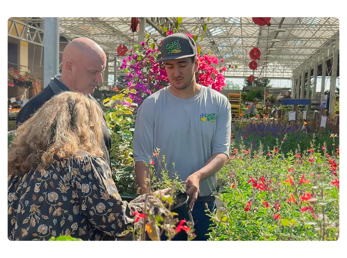 A plant and grow horticulture expert helping customers choose a plant. A plant and grow horticulture expert helping customers choose a plant.