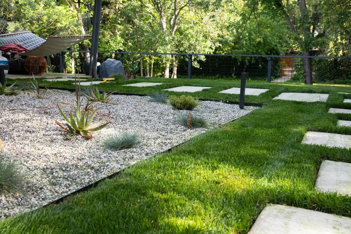 Studio Plumb backyard sod and stepping stones