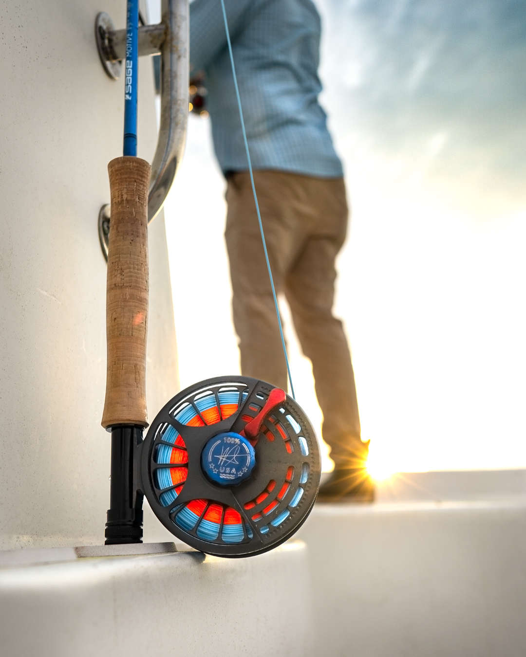 Seigler saltwater fly reel on boat with sun in background. Seigler saltwater fly reel on boat with sun in background.