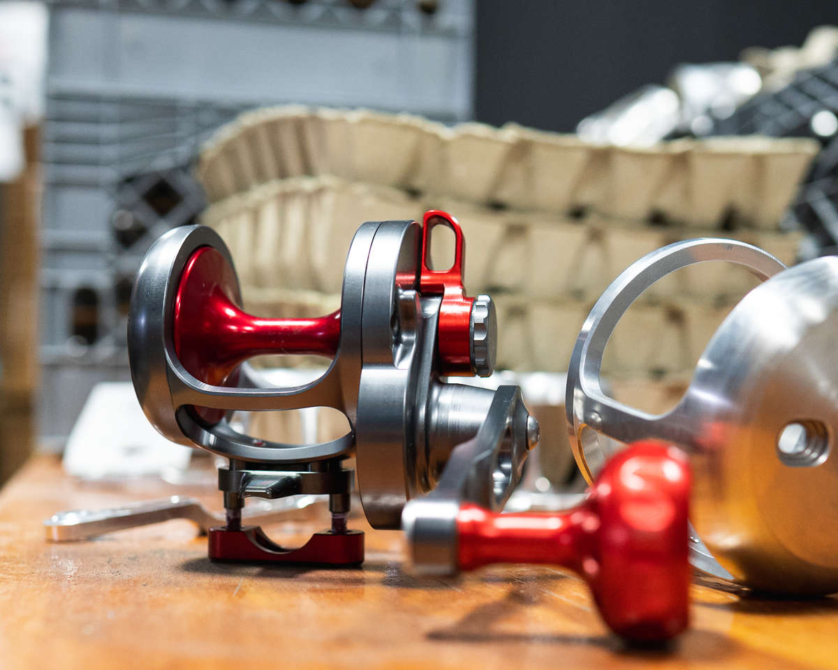 Red Fishing Reel next to raw material. Red Fishing Reel next to raw material.