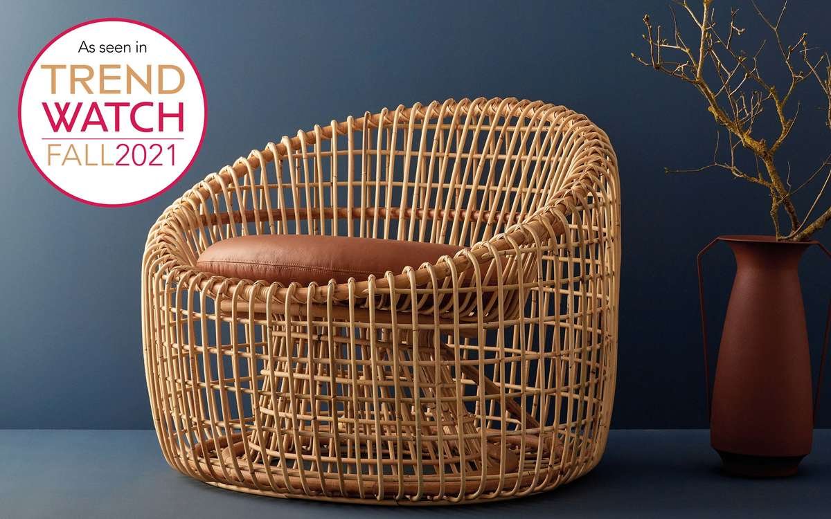 Round lounge chair made of rattan with brown leather cushion