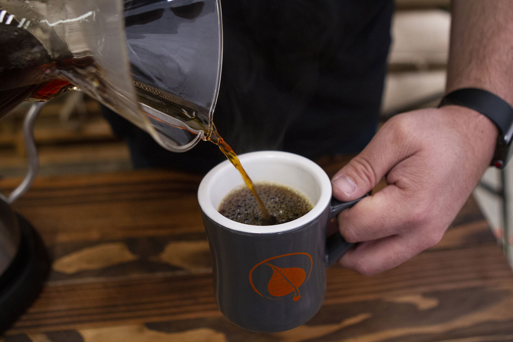 POURING COFFEE FROM CHEMEX INTO MUG