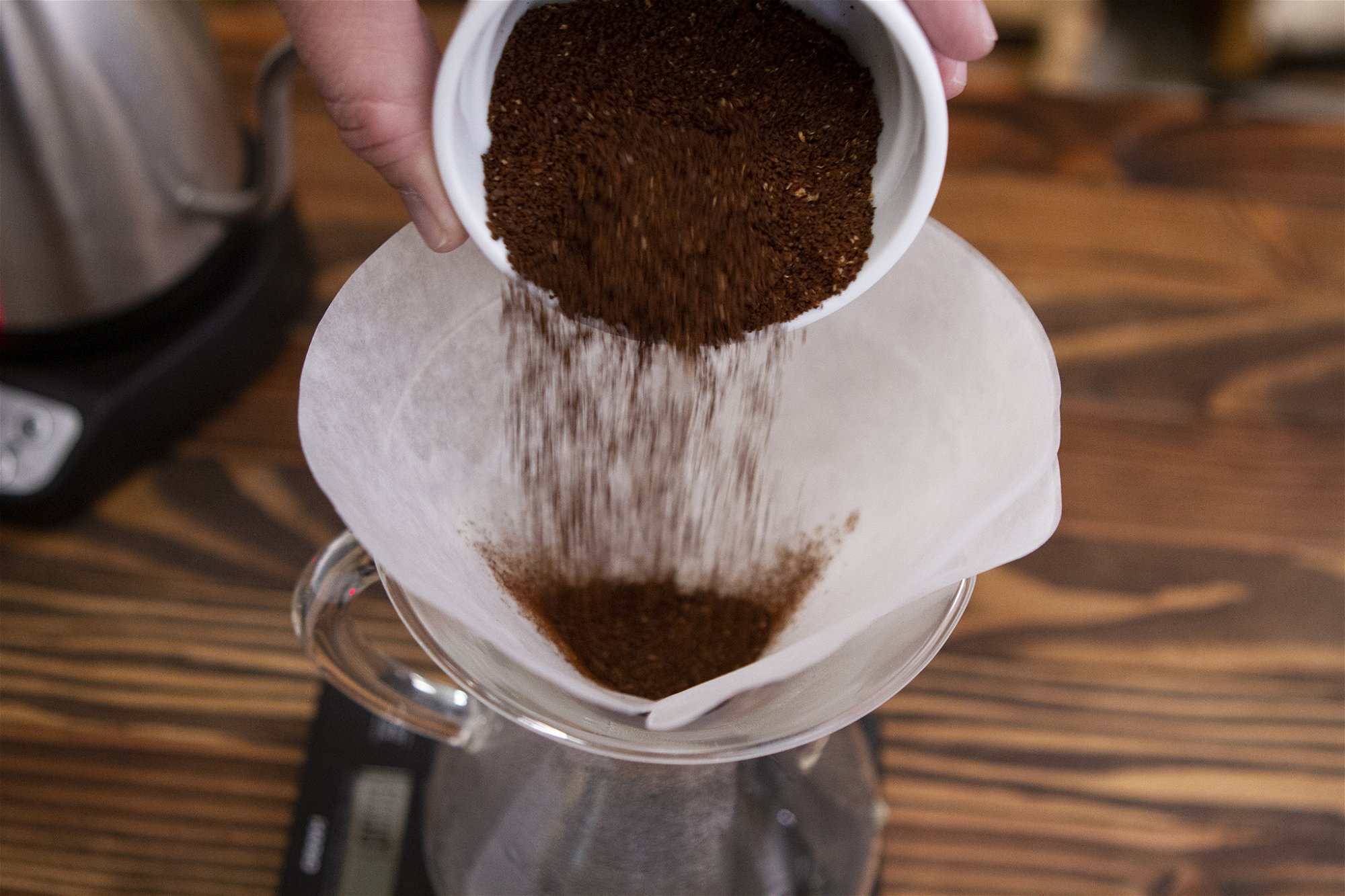 COFFEE GROUNDS POURING INTO CHEMEX