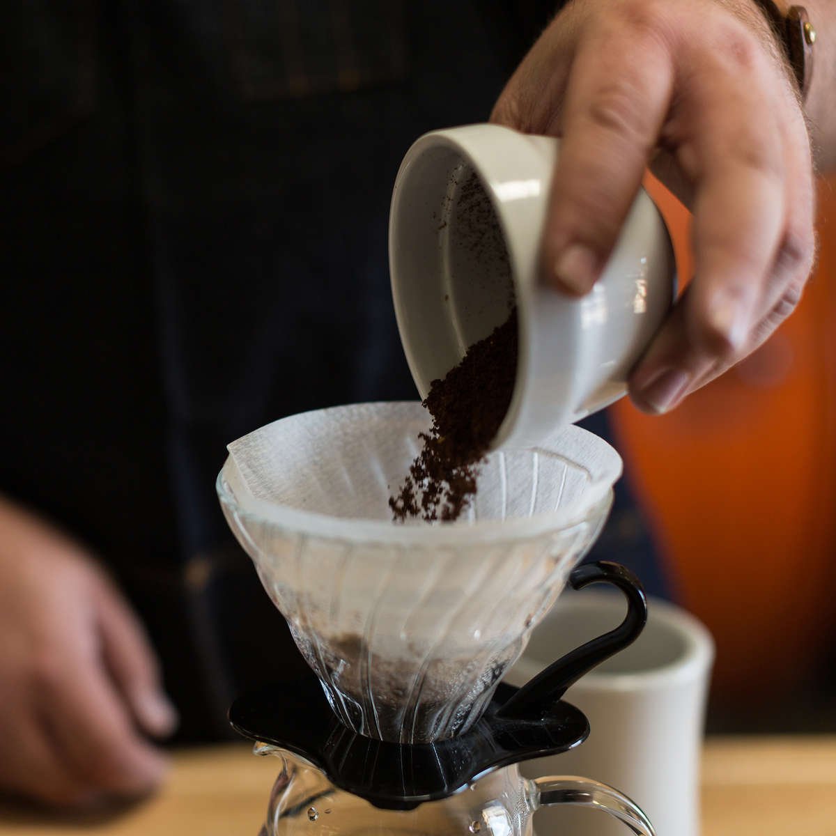 POURING COFFEE GROUNDS INTO V60