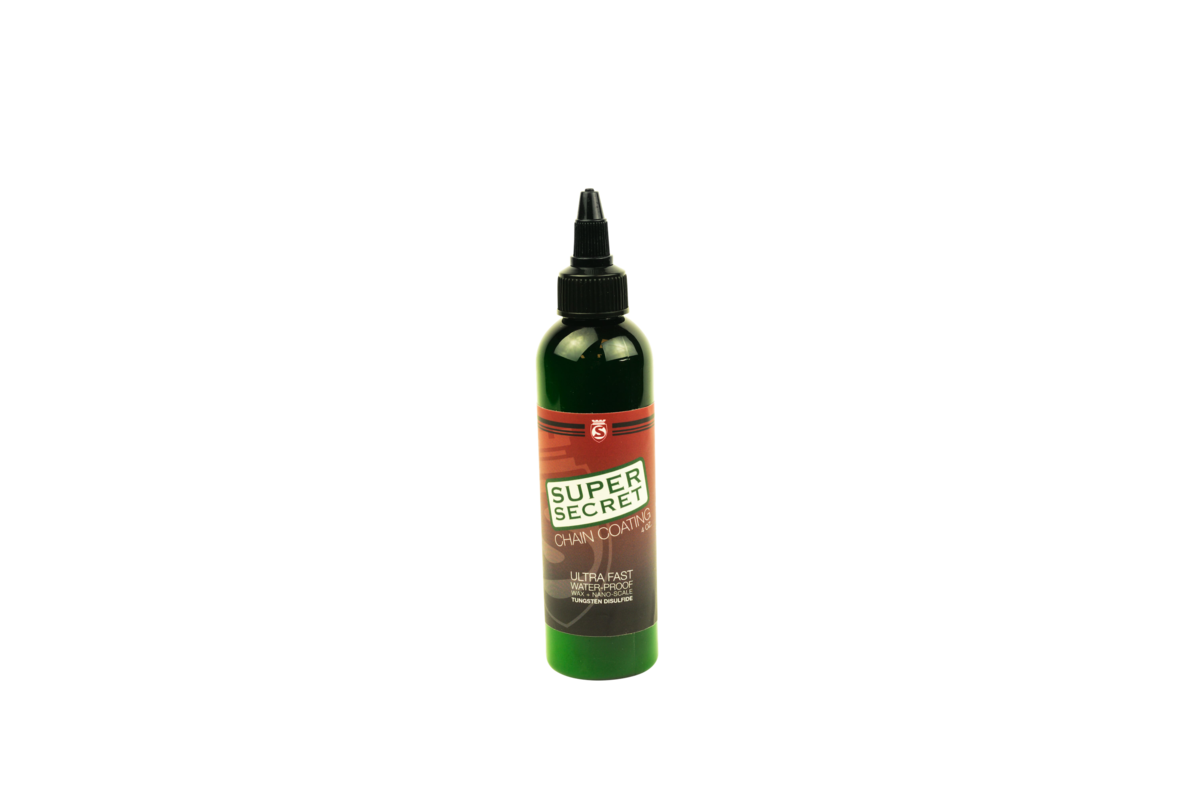 Object: white 4 oz squeeze bottle labeled "Super Secret" chain lube. Action: standing upright with capped nozzle. Context: isolated on a plain white background.