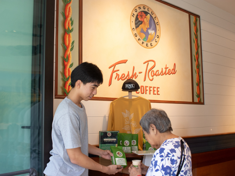 Barista showing customer Kona coffee
