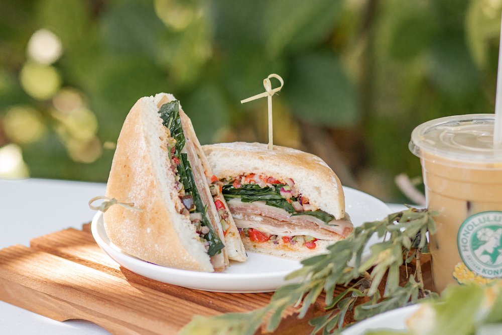 The Muffaletta Sandwich on a plate in tropical surrounds