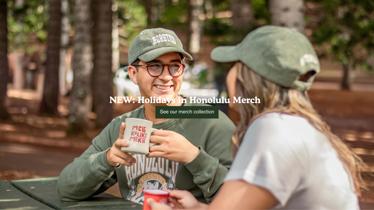 Two people with Honolulu Coffee merchandise