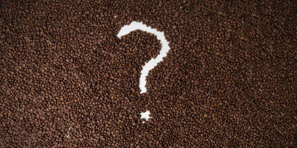 A question mark in a pile of roasted coffee beans
