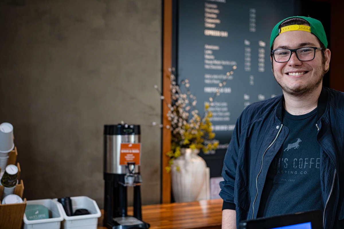 A barista smiles from behind the counter at Kaldi's in Emory's School of Medicine
