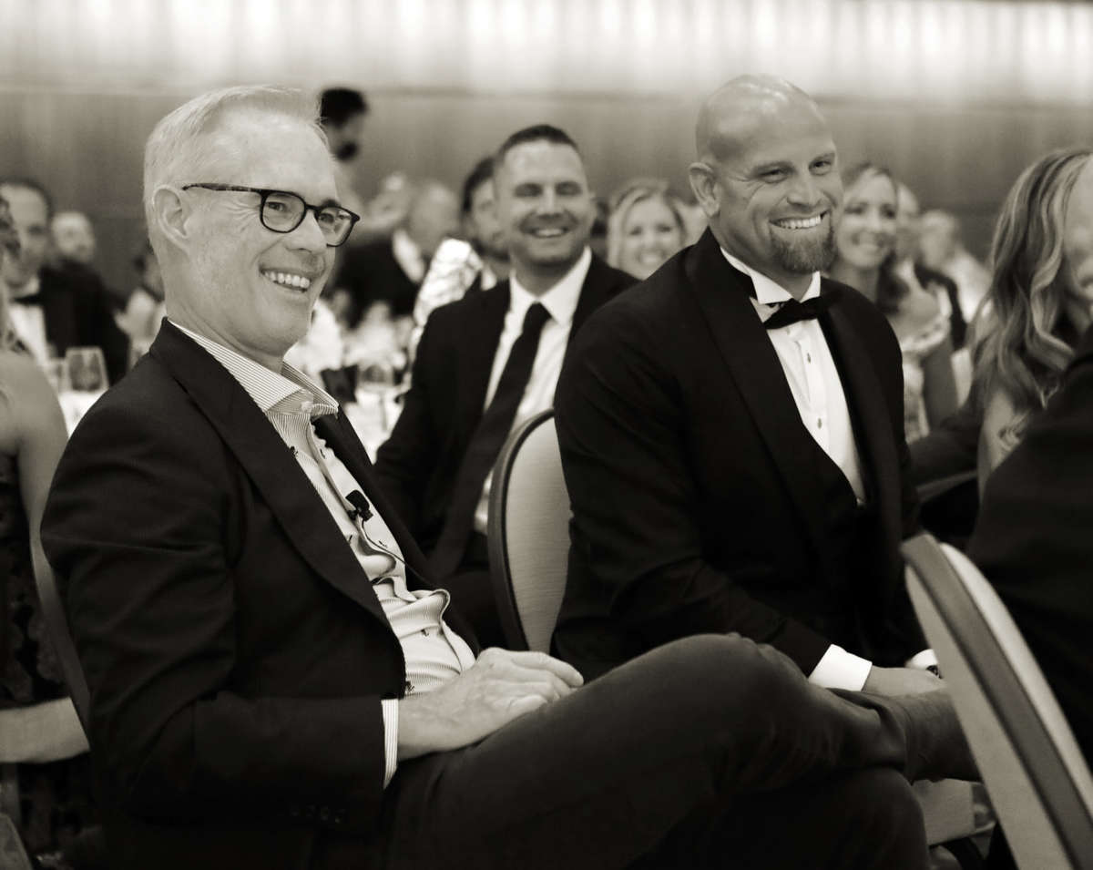 Joe Buck and Kyle McClellan smile in tuxedos 