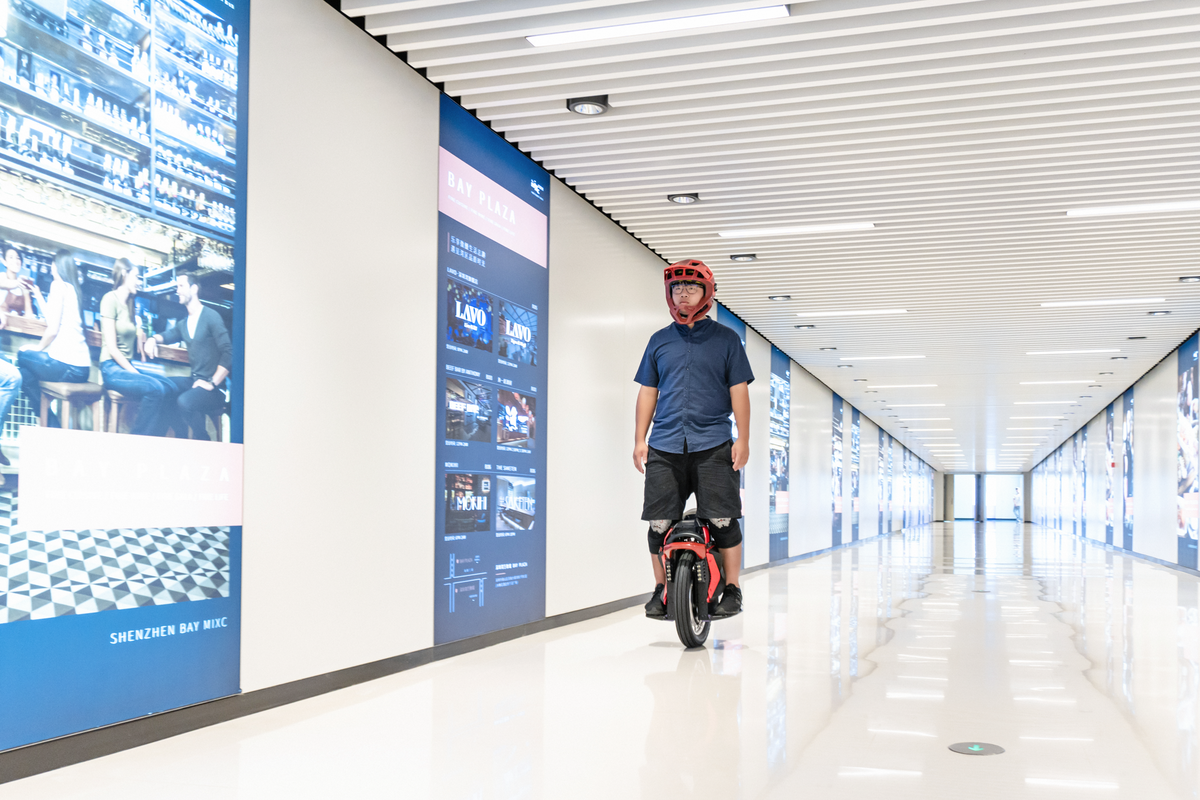 Person Riding King Song S22 Eagle Electric Unicycle in Hallway