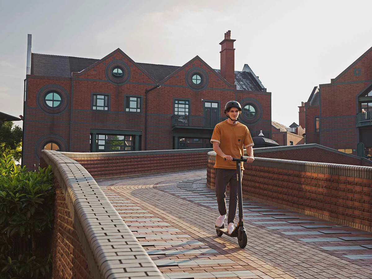 Boy Traveling on a Ninebot KickScooter by Segway