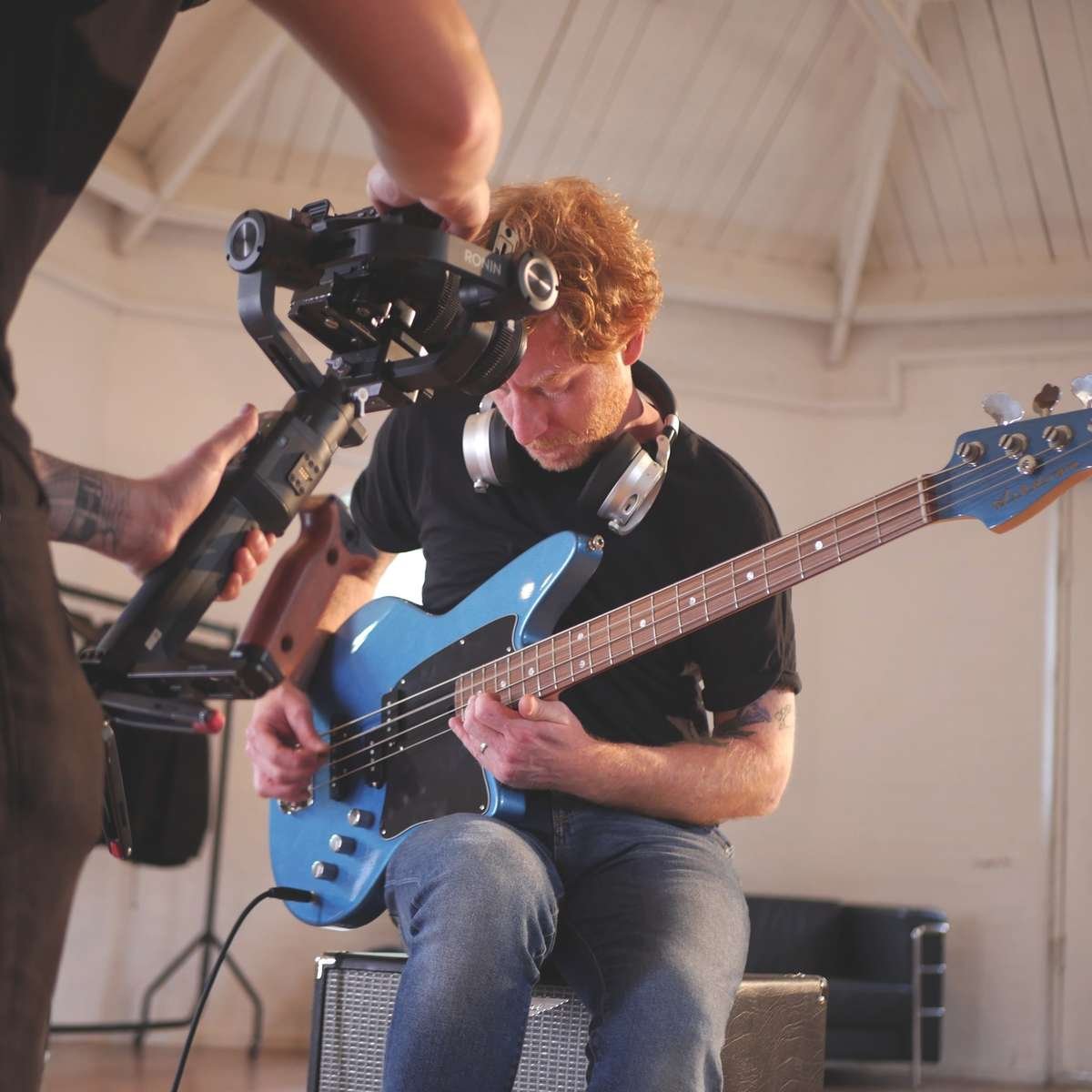 James Johnston playing the bass for a video