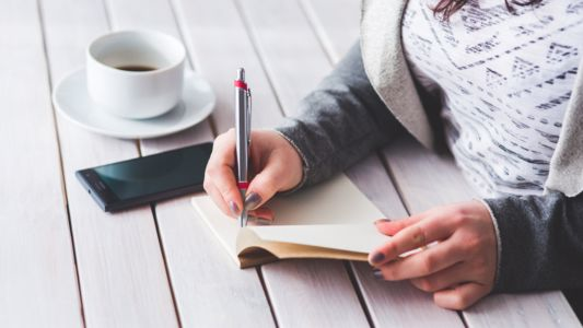 Woman writing in a journal