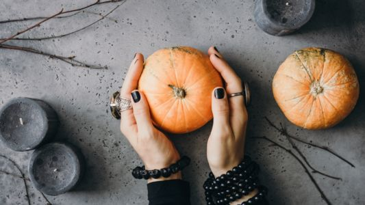 Hands Holding Pumpkin Display