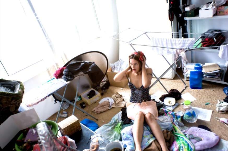 Woman at center of messy room