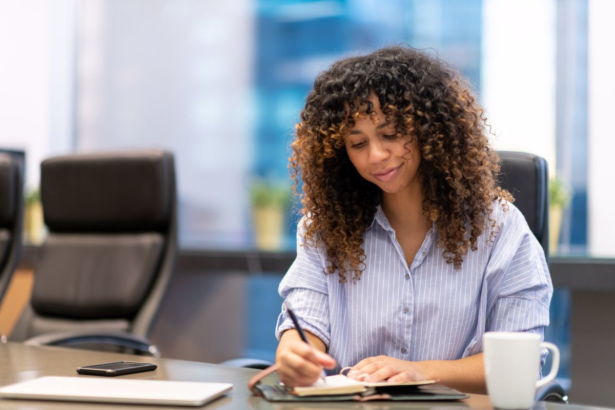 Woman Writing in Journal Memo Notebook