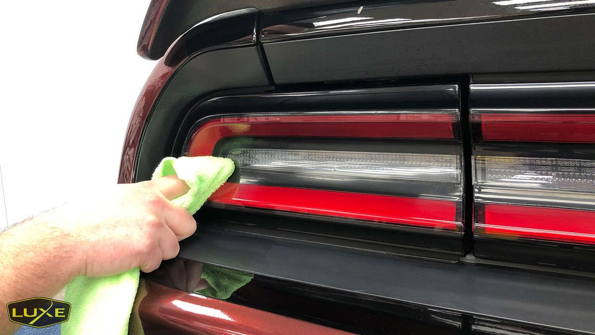 Dodge Challenger Hellcat taillight being cleaned