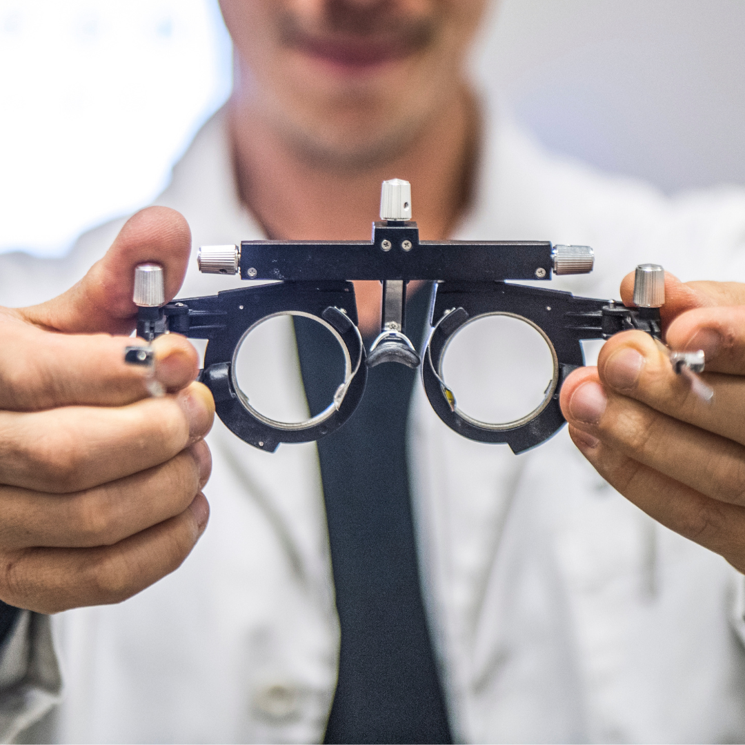 Optometrist is doing a Binocular Vision Assessment holding special optical glasses in front of the patient
